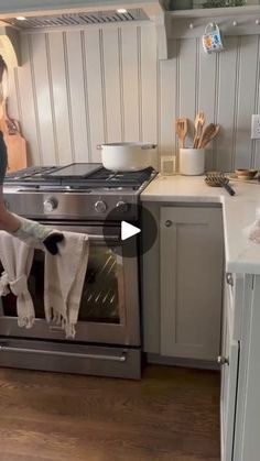 a woman is cleaning the oven in her kitchen