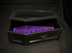 an empty black box with purple velvet inside