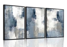 three blue and white paintings hanging on a wall