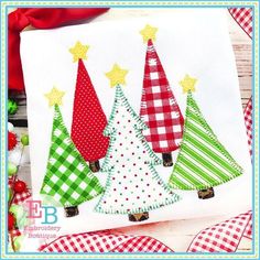 three christmas trees with stars and gingham checkered ribbon on the tablecloth