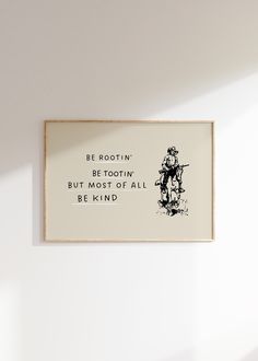 a white wall with a black and white drawing on it that says be rootin'be toothin'but most of all be kind