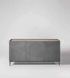 the sideboard is made out of wood and has an interesting pattern on it's sides