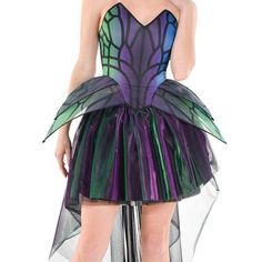 a woman in a purple and green dress with wings on her skirt is posing for the camera