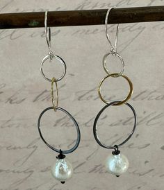 Fun and loopy! These gorgeous earrings will complement so many outfits.  Light and airy, great for summer! The top loop is sterling silver, the next one is slightly larger and it is gold filled, and the bottom loop is larger and darkened sterling.  The baroque style fresh water pearl that hangs from the third loop has a beautiful luster.  These will go well with other silver and gold jewelry. The hooks are sterling silver. Great gift for someone special. These earrings are ready to ship. Shipping is free and they will come in a nice box with a bow. Elegant Summer Dangle Hoop Earrings, Elegant Silver Pearl Earrings For Summer, Elegant Summer Hoop Earrings, Elegant Sterling Silver Hoop Earrings For Summer, Elegant Small Hoop Earrings For Summer, Silver And Gold Jewelry, Baroque Style, Fresh Water Pearl, Baroque Fashion