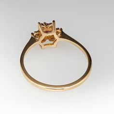 a yellow gold ring with an oval cut diamond