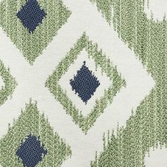 an upholstered fabric with blue, green and white designs on the outside of it