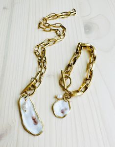 Make a statement with one of our beautiful Charleston Oyster Shell Bracelets. Chunky 12K Gold over brass chain with toggle closure and a one of a kind finished Oyster Shell and Ivory colored freshwater pearl charm. Natural oyster shell charms will range from approximately 1" to 1.5" and will vary slightly in color and shape. Two bracelet size options available, so you can choose what works best for you. Each shell has been harvested in our Charleston, SC rivers and are carefully hand finished to Silk Bag, Shell Bracelet, Oyster Shell, Pearl Charms, Detail Shop, Brass Chain, Charleston Sc, Ivory Color, Bracelet Sizes