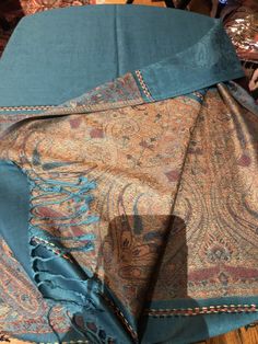 Light denim blue and beige Vintage styled wrap 28 X 70 Nice brocade paisley Very soft silk blend Styled from ancient Jamawar Indian motifs These are replicated from vintage shawl collections by my own company We may have larger quantities available for weddings, bridesmaids, or wholesale orders. Please inquire. All shipped free in the US Please check out our THOUSANDS of great reviews Blue Vintage Shawl, Traditional Blue Paisley Print Shawl, Traditional Blue Shawl With Paisley Print, Bohemian Blue Paisley Print Pashmina Shawl, Bohemian Blue Paisley Pashmina Shawl, Bohemian Blue Pashmina Shawl With Paisley Print, Blue Pashmina Silk Shawl, Blue Jamawar Shawl With Traditional Drape, Blue Jamawar Shawl In Traditional Drape