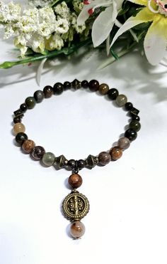 This is a beautiful brown gemstone and Bronze bracelet. It is lovingly handmade to a high standard using 6mm genuine A grade Picasso Jasper and Indian Agate gemstones,  alongside 4mm Snowflake Obsidan beads that are highlighted with antique bronze tibetan style beads and finished off with a beautiful dangling charm which dangles from the bracelet beautifully with an antique bronze bead. Agate cleanses and stabilises the aura, eliminating and transforming negativity. Agate enhances mental functio Bronze Bracelet, Bronze Bracelets, Chakra Racine, Brown Gemstone, Indian Agate, Picasso Jasper, Have A Shower, Beaded Jewellery, Crystal Healing Bracelets