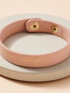 Leather bracelet with two snap button closures. Approx. width: 0.5" Material: Zinc, Gold plated, Leather Lead Compliant, Nickle Free Made in Korea (South) Korea South, I Am Enough, Snap Button, Leather Bracelet, Gold Plate, Blush, Plating, Bracelet, Electronic Products