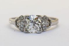 an antique style diamond ring on a white background