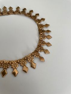 Vintage 1940s gold toned metal necklace decorated with  triangles and flowers. Era: 1930s -1940s Length: 19" Materials: gold tone , metal Condition: excellent ✩ visit the shop ✩ https://www.etsy.com/shop/Themagicstories2?ref=seller-platform-mcnav Thanks! Gold Costume Jewelry Necklace For Vintage Events, Vintage Brass Choker Necklace, Gold Vintage Necklace For Vintage Events, Vintage Gold Necklace For Vintage Events, Gold Vintage Necklace For Events, Vintage Gold-tone Brass Necklace, Vintage Brass Necklace For Vintage Events, Bohemian Gold Jewelry For Vintage Events, Vintage Brass Necklaces For Vintage Events