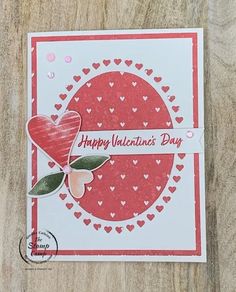 a valentine's day card with hearts and a heart on the front, sitting on top of a wooden table