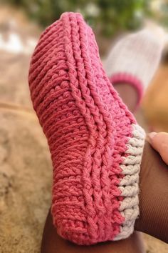 a person wearing pink and white knitted socks