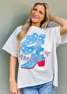 Step up your summer style in this playful Western boots graphic tee with 'America' sequin lettering embroidery. Perfect for Fourth of July festivities or just adding some fun and classic flair to your wardrobe. True to size Oversized fit intended Round neckline Pull on fit Sequin lettering embroidery Not lined 100% cotton Fabric has little stretch Comfortable Fit Graphic Tee For Summer, Comfortable Summer Graphic Tee, Comfortable Fit Summer Graphic Tee, Casual Summer T-shirt With Embroidered Graphics, Comfortable Summer T-shirt With Graphic Print, Comfortable Fit Graphic Print T-shirt For Summer, Comfortable Fit T-shirt With Text Print For Summer, Spring T-shirt With Glitter Print, Comfortable Fit Slogan Tops For Summer