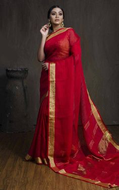 Linen sarees are always in demand.This handwoven red linen saree with pure gold zari border give you a unique style.The color is so vibrant that you are going to love it.Linen sarees are breathable,light weight and easy to drape. Fabric: Linen by linen  Thread count:100 count Saree Color: Red Occasion: Casual/Formal Saree length:5.50 mtr Blouse:80 cm Custom Stitching: Available upon request Saree Embroidery: Available upon request Blouse Stitching: Available upon request Shipping: 7 to 10 busine Red Slub Silk Saree With Weaving Work, Red Chanderi Saree With Weaving Work, Linen Saree With Cutdana Detailing, Traditional Linen Saree With Zari Work, Traditional Linen Saree With Cutdana, Traditional Linen Saree With Pallu, Linen Saree With Pallu, Traditional Linen Saree For Festive Occasions, Linen Cutdana Saree For Festive Occasions