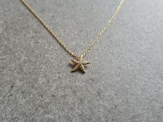 These lovely necklaces are made using unique 11.4 x 10.6mm 16k gold plated brass starfish charms. These are attached to an 18 inch matte gold plated over brass diamond cut chain.  They are perfect for people who love being by the sea. Gold Star Charm Necklace For Beach, Gold Charm Necklace With Star Charm For Beach, Gold Charm Necklace With Star For Beach, Dainty Gold Starfish Charm Necklace, Star Charm Necklace For Beach, Star Charm Necklaces For Beach, Yellow Gold Starfish Charm Necklace For Beach, Dainty Starfish Necklace For Beach, Yellow Gold Necklace With Starfish Charm For Beach