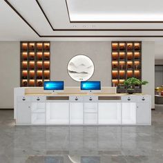 an office lobby with two computers on the desks and a circular mirror above it