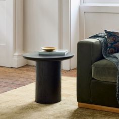 a living room scene with focus on the coffee table and sofa in the foreground