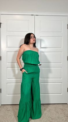 This stylish jumpsuit features a wide leg ruffle tiered design and two side pockets. Crafted from a high-quality fabric blend, it is sure to be an eye-catching addition to your wardrobe. 80% Rayon 20% Nylon Summer Solid Color Wide-leg Jumpsuits And Rompers, Solid Color Summer Jumpsuits With Wide-leg Pants, Solid Color Summer Jumpsuits And Rompers With Wide-leg Pants, Summer Wide-leg Jumpsuits And Rompers In Solid Color, Green Sleeveless Dress With Elastic Waistband, Green Wide-leg Jumpsuits And Rompers For Spring, Green Wide Leg Jumpsuits And Rompers For Spring, Casual Strapless Sleeveless Jumpsuit With Elastic Waistband, Green Sleeveless Ruffled Jumpsuits And Rompers