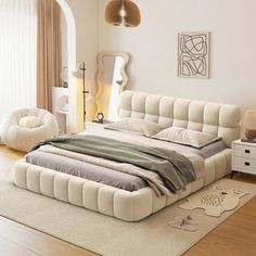 a large white bed sitting on top of a wooden floor next to a dresser and lamp