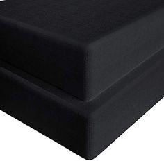 a black bed frame with no sheets on it