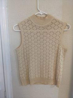 "Beautiful vintage knit top from St. John collection by Marie Gray.  Size is P.  Perfect to wear alone or under a blazer.  The style is simple and timeless.  There is a tag that reads dry clean only.  Very nice condition with no stains or holes.   length - 20\" chest - 32\"" Classic Beige Pointelle Knit Tops, Vintage Beige Tops For Layering, Beige Vintage Tops For Layering, Classic Knit Tank Top, Classic Knit Sleeveless Tank Top, Classic Beige Vest Top, Classic Sleeveless Spring Sweater, Classic Sleeveless Sweater For Spring, Retro Cotton Sleeveless Sweater