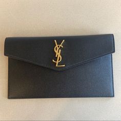 Brand New 100% Authentic Approx. 6.2"H X 10.6"W X 0.7"D Questions? Leave A Comment Below! Designer Office Clutch With Dust Bag, Luxury Envelope Clutch For Formal Occasions, Modern Envelope Wallets For Evening, Ysl Uptown Pouch, Designer Black Envelope Clutch, Luxury Black Envelope Clutch, Ysl Small Envelope Wallet, Ysl Black Envelope Bag, Yves Saint Laurent Wallet