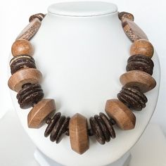 This beautiful and incredibly fun necklace has different wooden beads and coconut shells. It is an absolutely perfect and unique piece to wear while on vacation or if you're looking for something different to add to your jewelry collection! 26 inches Thank you for visiting my shop! LOVE LUCK AND BLESSINGS Artisan Brown Beaded Necklace For Beach, Beach Necklace With Brown Round Beads, Vacation Jewelry With Wooden Beads, Nature-inspired Beaded Necklace With Wooden Beads, Natural Wooden Beads Necklace, Unique Brown Fair Trade Necklace, Nature-inspired Wooden Beaded Necklace, Beaded Brown Necklace For Vacation, Brown Beaded Necklaces For Vacation