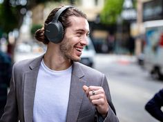 a man wearing headphones walking down the street