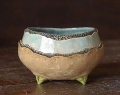 a ceramic bowl sitting on top of a wooden table