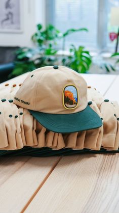 5-Panel 100% Cotton Cap. Featuring an embroidered patch on the front, lettering on the side, and an adjustable metal buckle. Designed for a landmark more than deserving of celebration. Perfect for the trails, the streets, or the sandy dunes of Bluffers Park. Adjustable Six-panel Snapback Hat With Embroidered Logo, Adjustable 5-panel Fitted Hat With Embroidered Logo, Six-panel Trucker Hat With Embroidered Logo, Outdoor Cap With Letter Patch, Outdoor Snapback Cap With Embroidered Patch, Outdoor Snapback Hat With Curved Brim And Embroidered Patch, Outdoor Baseball Cap With Letter Patch, Outdoor Letter Patch Cap, Outdoor Logo Patch Six-panel Snapback Hat