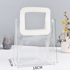 This item is only for one piece. Material: PVC Color: clear Size: A, B A: 18*10*20cm / 7.1*3.9*7.9 in B: 25*15*28cm / 9.8*5.9*11.0 in SKU:952-120 This item is only for one piece. Material: PVC Color: clear Size: A, B A: 18*10*20cm / 7.1*3.9*7.9 in B: 25*15*28cm / 9.8*5.9*11.0 in SKU:952-120 Souvenir Bags, Clear Handbags, Transparent Top, Wedding Souvenir, Creative Gift Wraps, Clear Tote Bags, Counter Design, Gift Totes, Transparent Bag