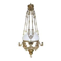 an antique chandelier hanging from the ceiling