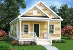 a small yellow house sitting on top of a lush green field