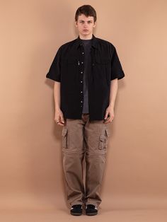 A vintage short-sleeved workwear shirt from the 80s, made from 100% cotton.  Vintage condition level: 9/10.  Model Kristofers is 6'2 ft (1.90 cm), 167 lbs (76 kg) and he wears the size available. SIZE: Marked size 45/46, fits like the size XXL. To be sure it would fit you, please check the measurements below. FLAT Measurements: Length: 33 1/2" / 85.5 cm Armpit to armpit: 27" / 68.5 cm SKU: F180 Every item is authentic vintage, one-of-a-kind. You will receive the exact item shown in the photos. T Cotton Shirt With Multiple Pockets And Relaxed Fit, Collared Cotton Tops With Multiple Pockets, Utility Cotton Shirt With Multiple Pockets, Cotton Utility Shirt With Multiple Pockets, Short Sleeve Utility Shirt With Flap Pockets, Utility Shirt With Flap Pockets And Short Sleeves, Utility Cotton Shirt With Cargo Pockets, Cotton Utility Shirt With Cargo Pockets, Utility Style Short Sleeve Relaxed Fit Shirt