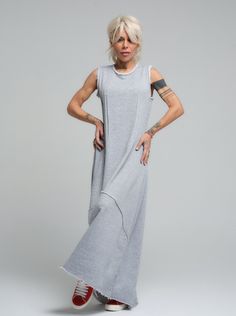 Our grey maxi dress is the epitome of laid-back chic, made from soft viscose that drapes beautifully for a comfortable yet stylish look. Its sleeveless design and subtle scoop neckline offer a casual elegance that's perfect for sunny days or layered under a jacket when the evening cools down. FEATURES:Sleeveless with a relaxed fit and a long, flowing silhouette. Ideal for leisurely weekend wear or as a base for accessorizing100% Handmade. SIZE & FIT: Fit: A relaxed fit with room to moveModel is wearing size Small or S/M View our SIZE CHART before ordering MATERIALS & CARE: Content: 65% Cotton, 35% Polyester Care: Machine wash on cold (30ºC) with a mild detergent. SHIPPING: Made to order, the processing time is 15 working days This item will be shipped via DHL Casual Sleeveless Maxi Dress For Loungewear, Casual Gray Sleeveless Maxi Dress, Sleeveless Gray Maxi Dress For Spring, Gray Lagenlook Summer Dress, Summer Viscose Maxi Dress With Side Slits, Chic Gray Maxi Dress, Gray Loungewear Dress For Summer, Gray Summer Loungewear Dress, Grey Maxi