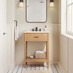 a bathroom with a sink, mirror and towel rack