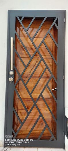 a wooden door with metal bars on the sides and an ornamental design inlayed to it