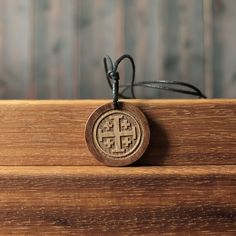 Christian Symbolism: The Jerusalem cross is primarily associated with Christianity and the significance of Jerusalem in Christian history. The large central cross represents the crucifixion of Jesus Christ, while the four smaller crosses symbolize the spread of Christianity to the four corners of the world. Material: Solid sycamore wood, cotton cord, wood paint, pine resin varnish. Pendant weight approx: 5g. Pendant thickness approx: 6mm. Pendant diameter approx: 35mm x 35mm. Pendant cord length Symbolic Engraved Cross Necklaces, Symbolic Cross Necklace As Gift, Symbolic Cross Necklace Gift, Symbolic Cross Pendant Necklace, Symbolic Handmade Cross Pendant Necklace, Handmade Symbolic Cross Pendant Necklace, Persephone Necklace, Christian Symbolism, The Crucifixion Of Jesus