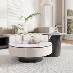 a living room with white couches and a table in the middle on carpeted flooring