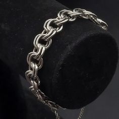 This vintage Monet bracelet features silver tone chain links and measures 7.5" L. It has a safety chain and is signed on both a hang tag and on the back of the clasp Classic Silver Chain Metal Bracelet, Metal Box Chain Link Bracelet, Classic Metal Chain Link Charm Bracelet, Formal Stainless Steel Silver Chain Bracelet, Formal Metal Charm Bracelet With Chain, Metal Link Charm Bracelet, Vintage Silver Bracelets With Adjustable Chain, Metal Chain Link Charm Bracelet With Lobster Clasp, Formal Metal Charm Bracelet With Adjustable Chain