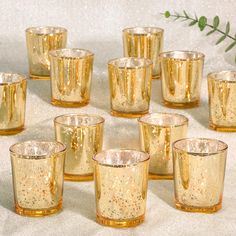 many gold colored glass cups are lined up