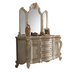 an antique style dresser with mirror and drawers