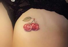 a woman's stomach with two cherries painted on the side of her belly