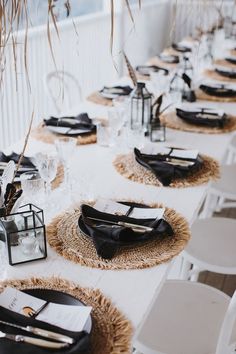 the table is set with black and white place settings