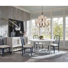 a dining room table with chairs and a chandelier