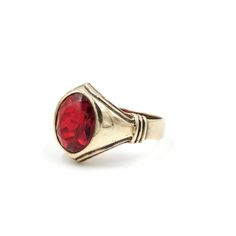 "Classic 10Kt yellow gold signet ring with a red ruby glass center. Incredible Art Deco style lines and detailing set this ring apart from similar statements. This ring has stood the test of time but does show signs of wear as the glass facets are heavily worn with a few flea bites (best seen in photo #8). Light scratching to the gold but nothing major. A jeweler could replace the glass with a stone if you want a different look.  Marked \"10K\" and tested to guaranteed 10 karat gold. Size: 8.75  Measures: .63\" tall (in front)  Weight: 5.52 grams Please feel free to contact me with questions and/or for additional photos. More gold pieces in the shop: 14Kt Gold Band - https://etsy.me/3vu8JiQ 14Kt & Seed Pearl Brooch - https://etsy.me/391Uw59 *Free Domestic Shipping on Orders Over $35* All i Antique Red 14k Gold Signet Ring, Antique Red Signet Ring In 14k Gold, Heirloom Red Signet Ring With Polished Finish, Modern Red Ring For Formal Occasions, Modern Red Rings For Formal Occasions, Antique Red Gemstone Signet Ring, Antique Ruby Rings With Polished Finish, Vintage Ruby Rings With Polished Finish, Modern Hallmarked Red Rings