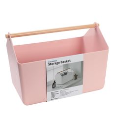 a pink storage basket with wooden handles on the top and bottom, for storing items