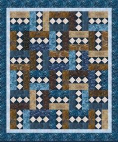 a blue and brown quilt with squares on the front, one block in the middle